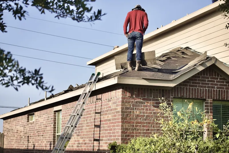Professional roofer working on a residential roof in Burlington